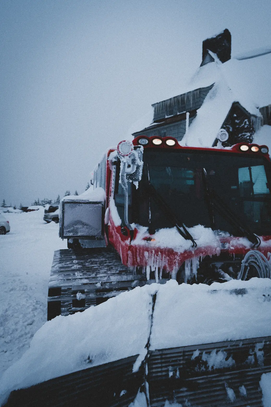 A large machine that can carry people with treads in the snow called a Snow CAT