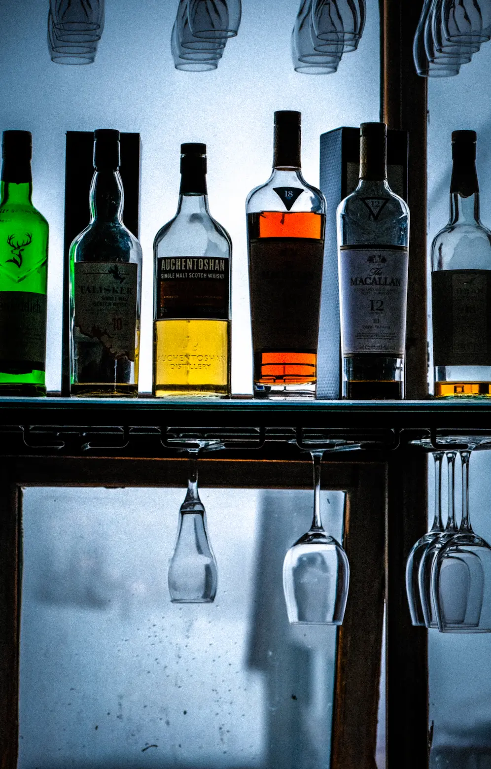 Bottles of Liqour are featured with glasses, snow visible in the background.