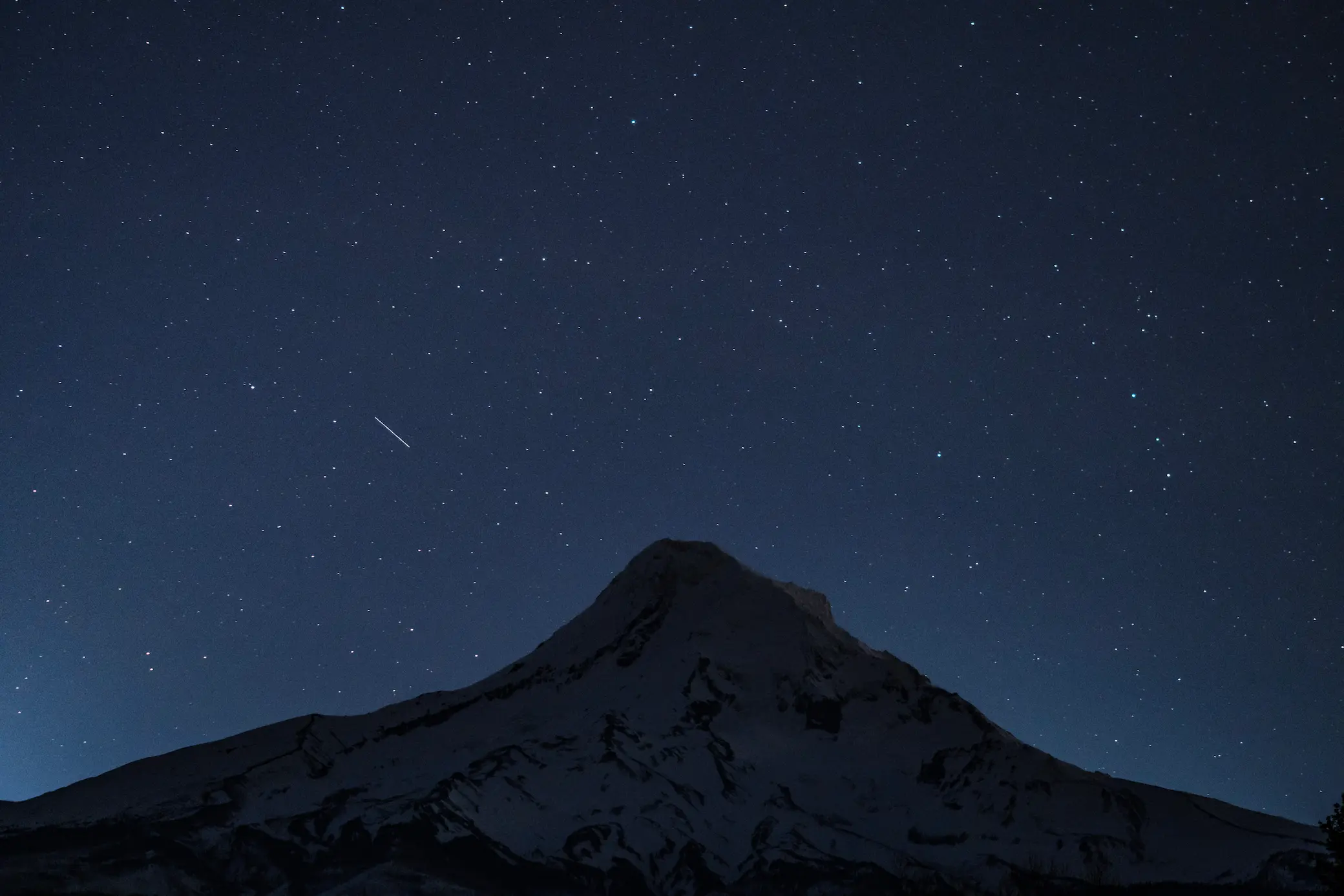 Starry scene with a semi-silhouette of Mt. Hood 