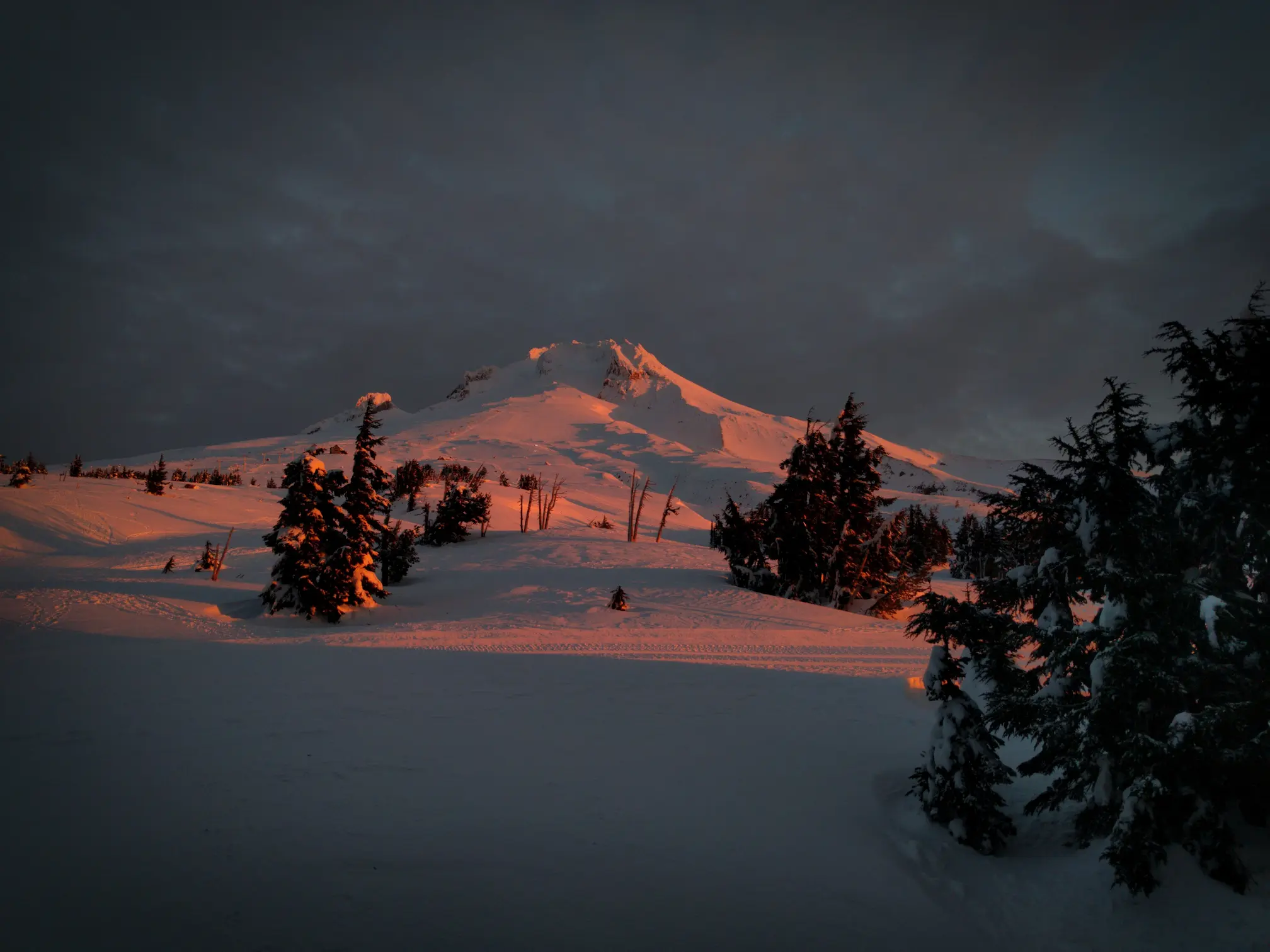 Sunrise that is reddish-orange on the south side of Mt. Hood